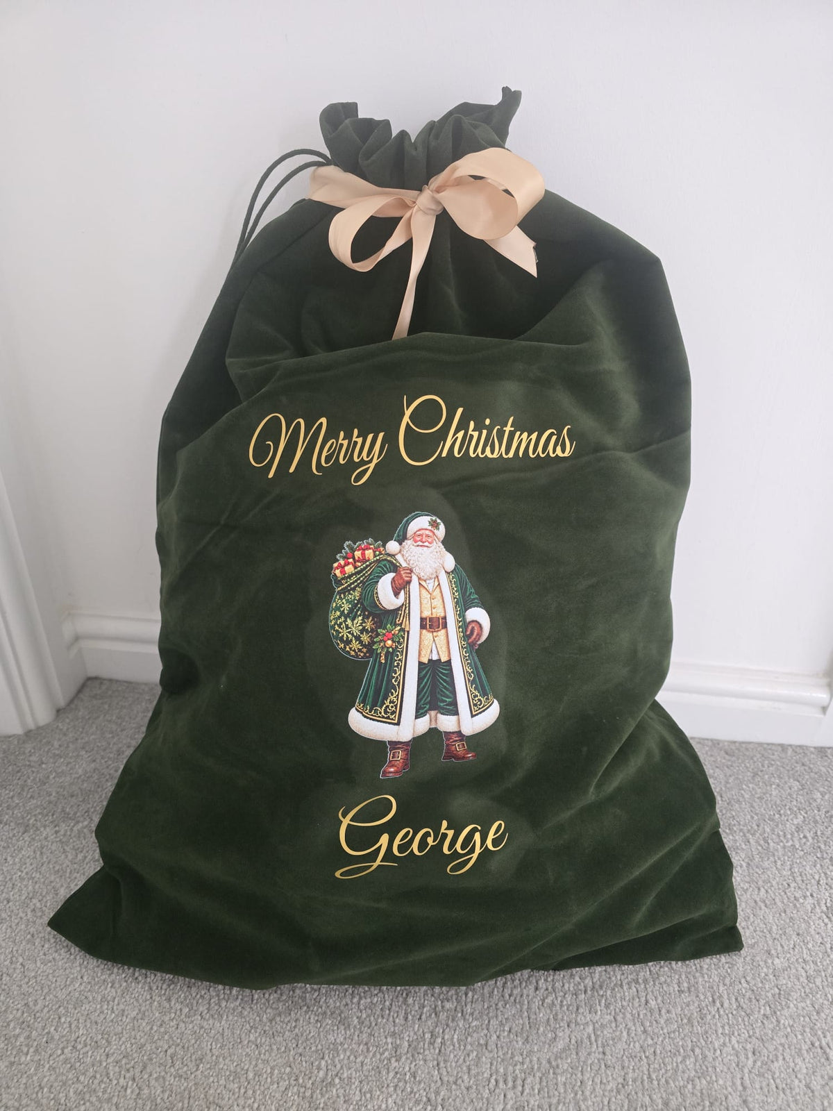 Personalised green velvet Christmas sack with gold lettering, Santa design and custom name, perfect for Christmas gifts.