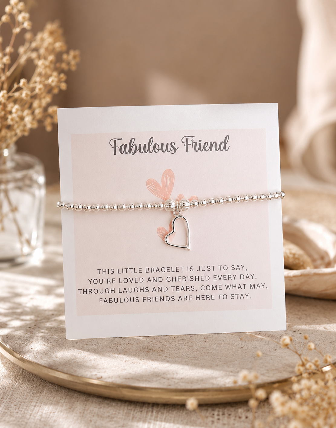 Heart-shaped bracelet on a 'Fabulous Friend' card with decorative elements.