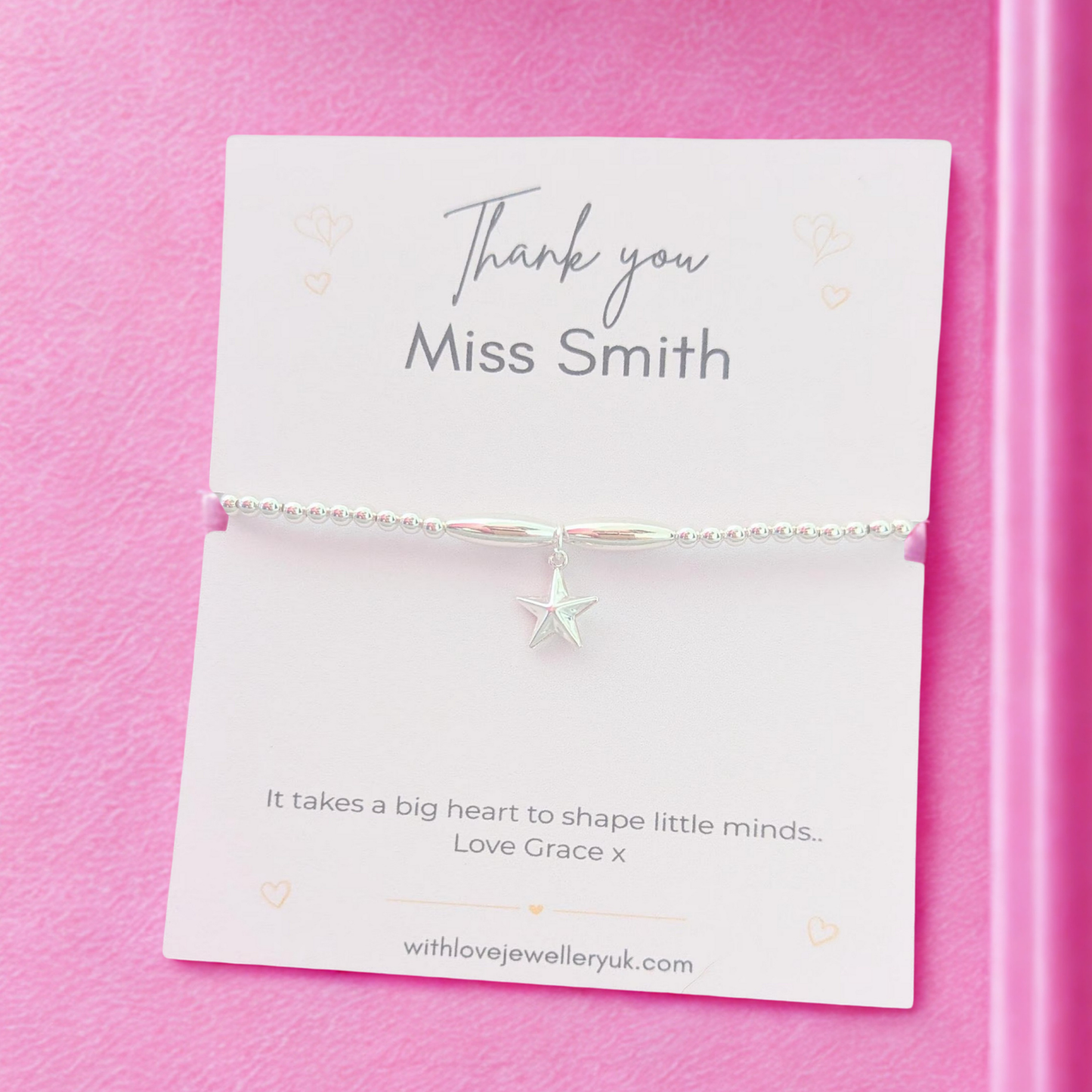 Jewelry card with a starfish charm on a pink background