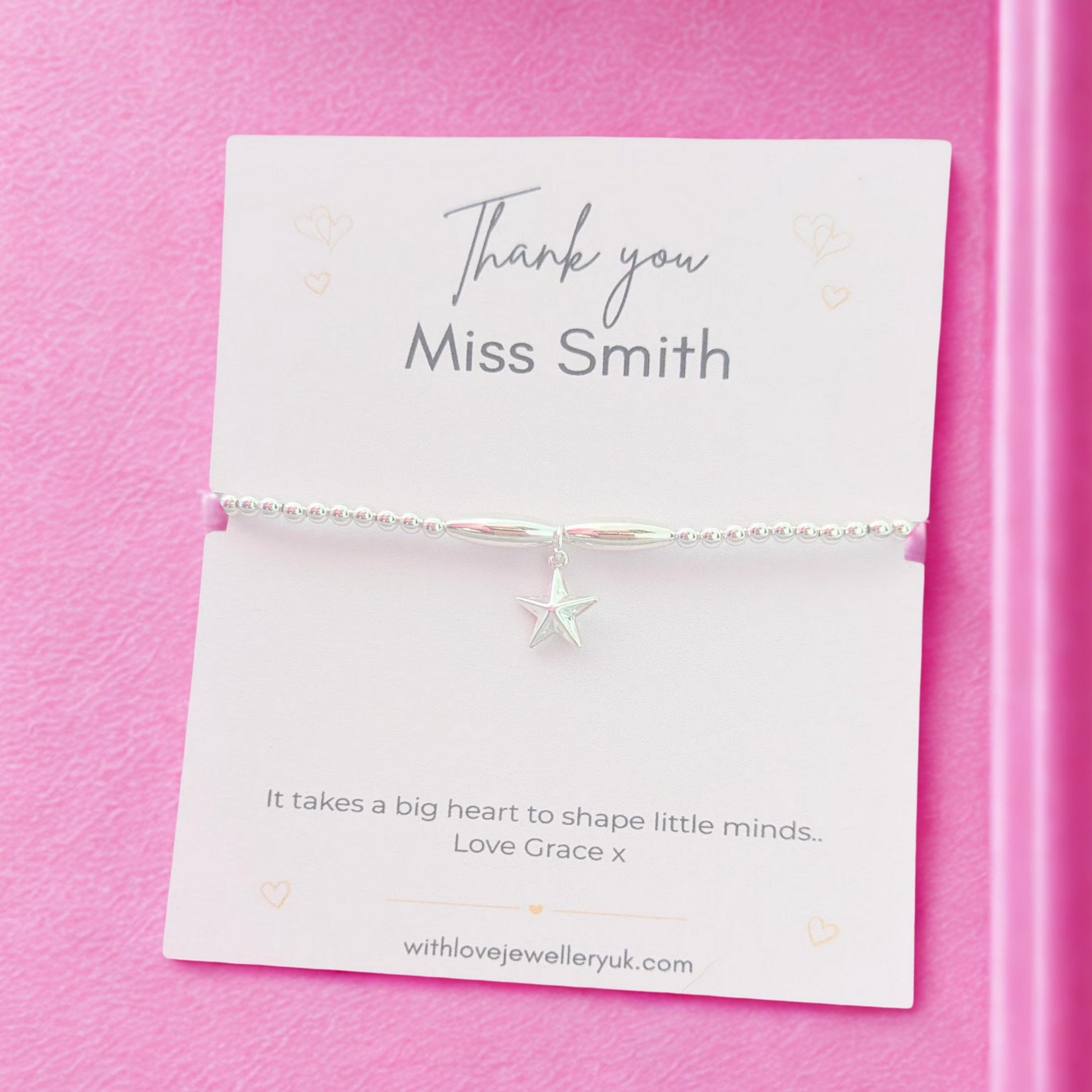 Jewelry card with a starfish charm on a pink background
