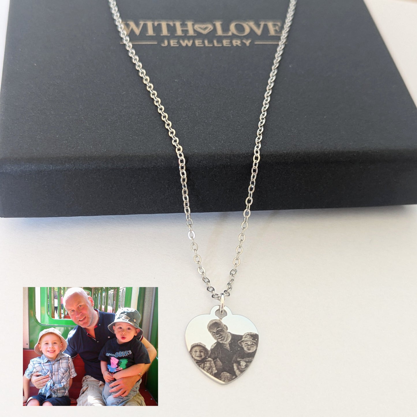 Silver necklace with a heart-shaped pendant featuring a photo of a man and two children, displayed on a 'With Love Jewellery' box.