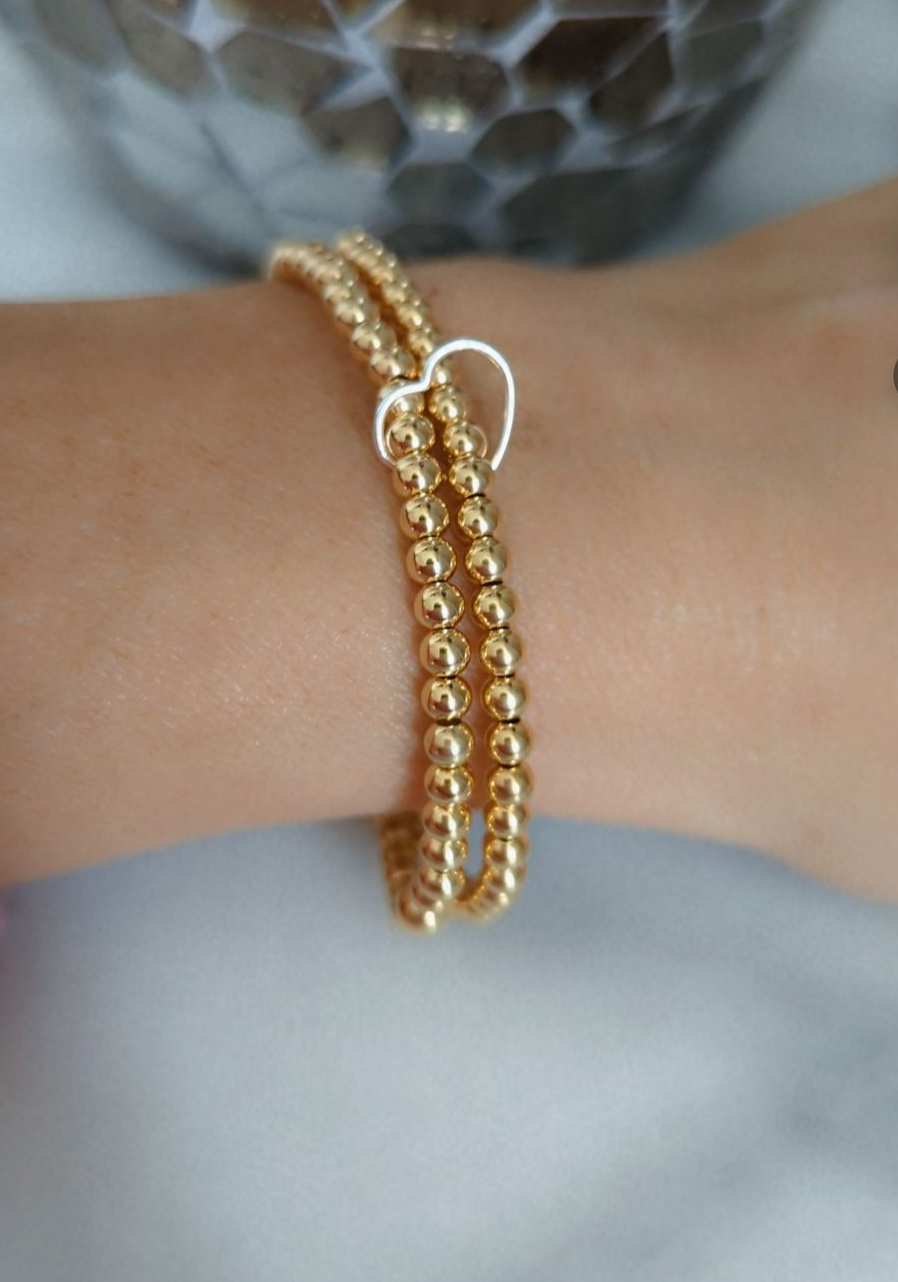 Double gold beaded bracelet, linked with a heart.