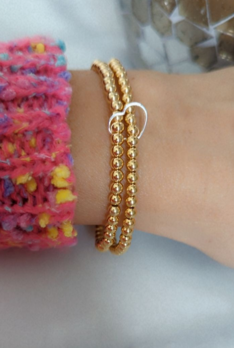 Double gold beaded bracelet, linked with a heart.