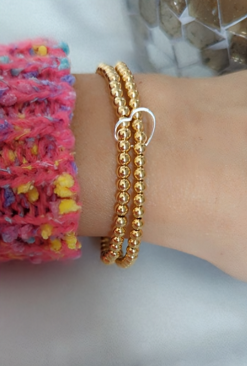 Double gold beaded bracelet, linked with a heart.