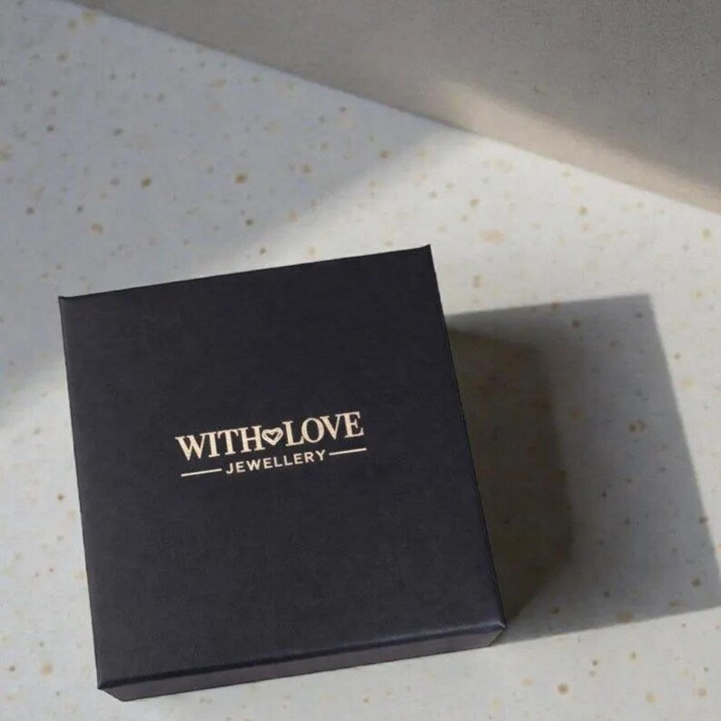 Black jewelry box with 'WITH LOVE JEWELLERY' logo on a textured surface