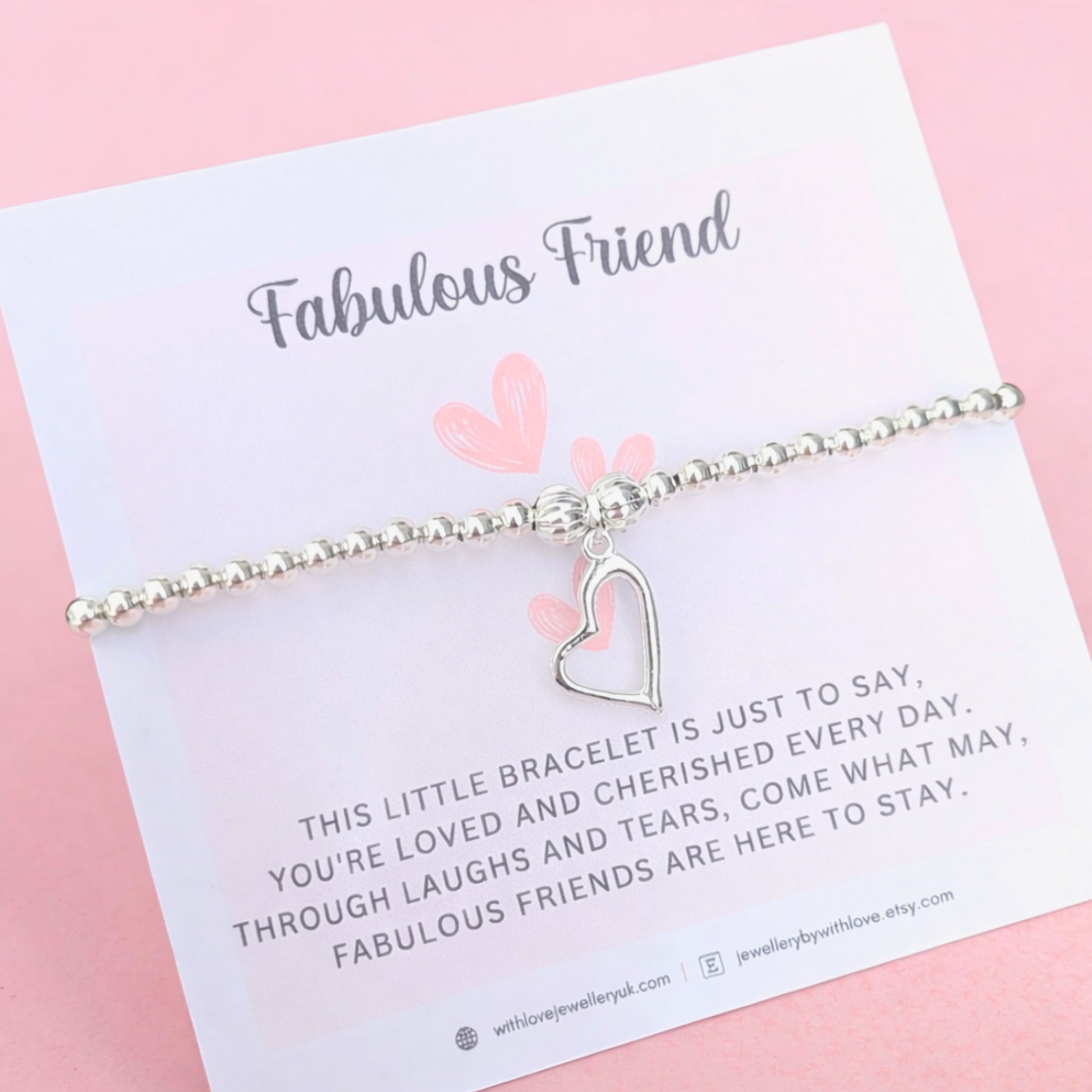 Silver bracelet with heart charm on a 'Fabulous Friend' card against a pink background