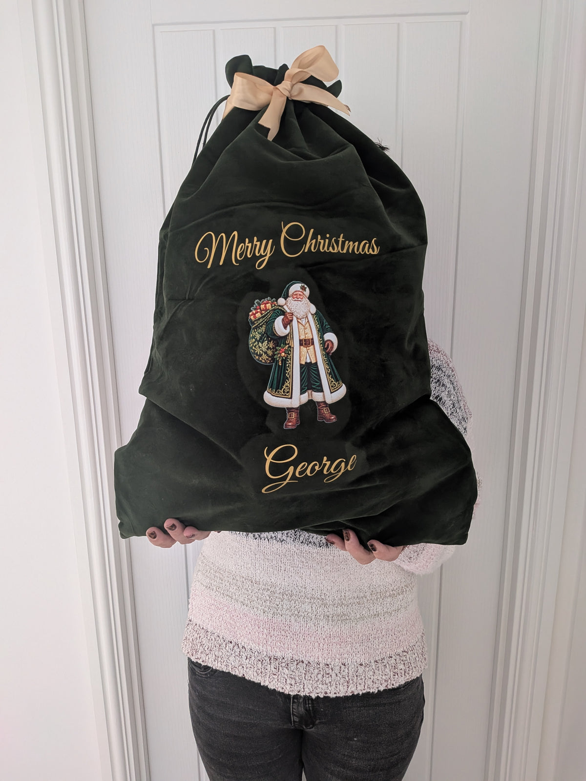 Personalised green velvet Christmas sack with gold lettering, Santa design and custom name, perfect for Christmas gifts.